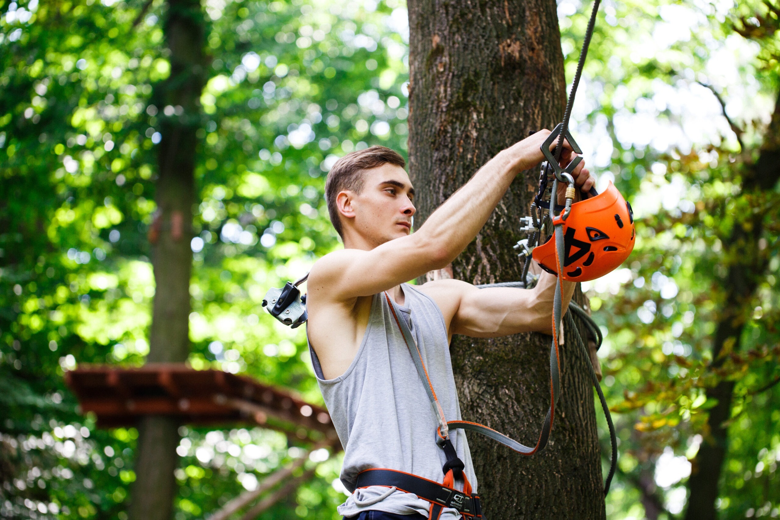 Home man prepares to climb on the ropes in the park
